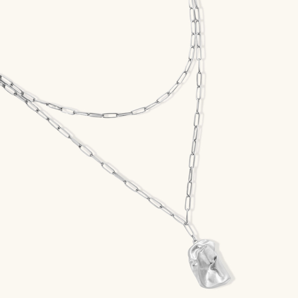Layered paperclip chain necklace with organic flowing pendant made from eco-zinc alloy in warm gold finish