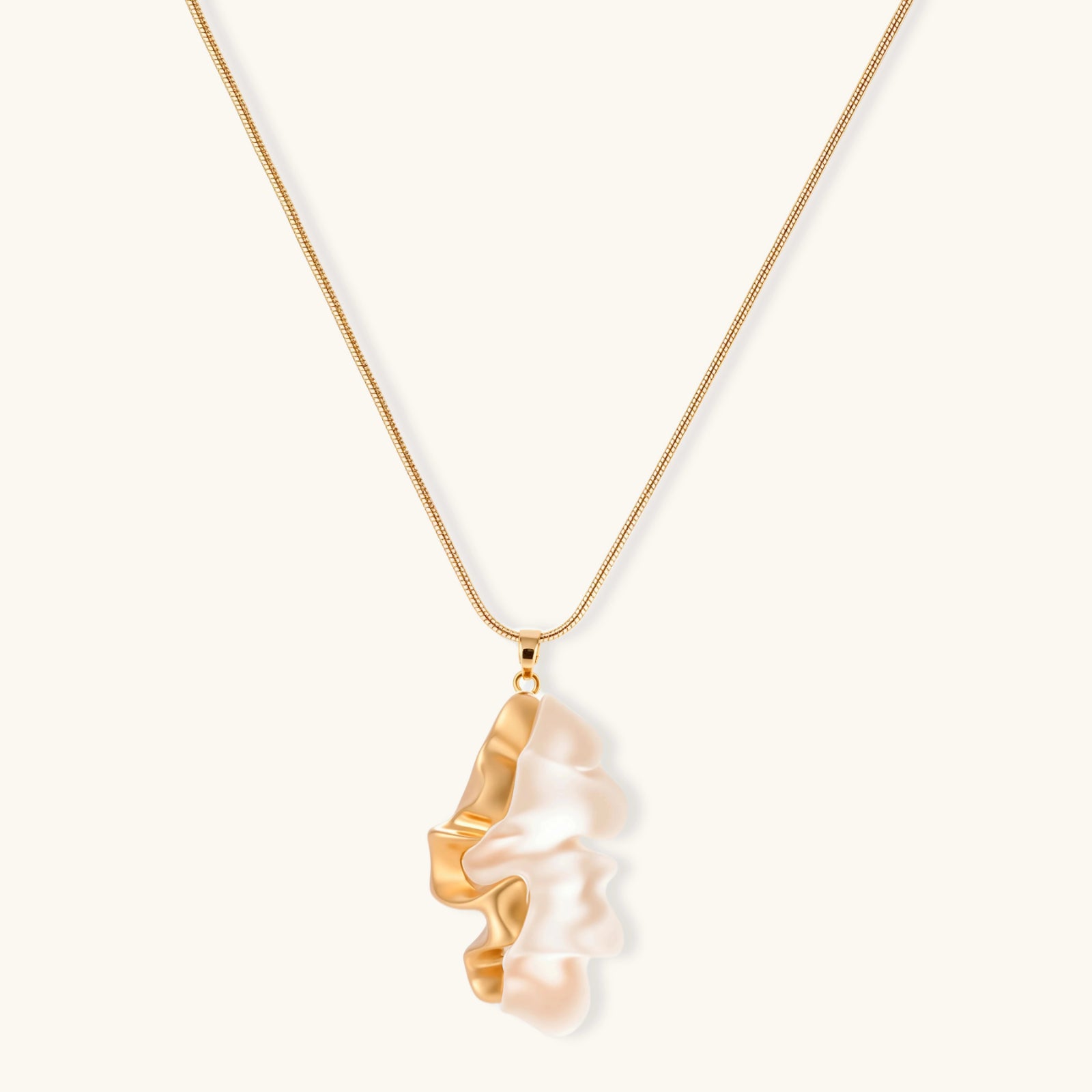 Close-up of a sculptural necklace with flowing wave pendant made from eco-zinc alloy on adjustable chain