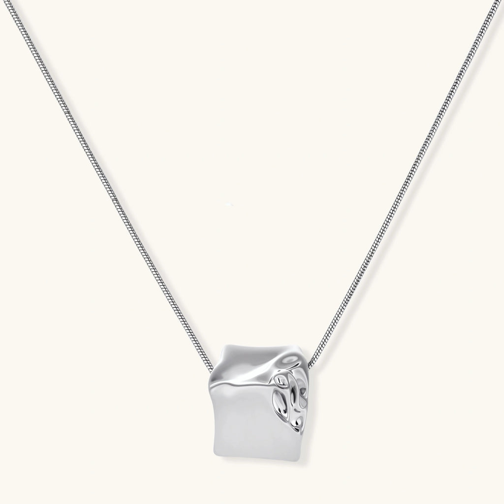 Geometric jewelry set with textured cube pendants on chains, featuring eco-zinc alloy in silver and gold finishes.