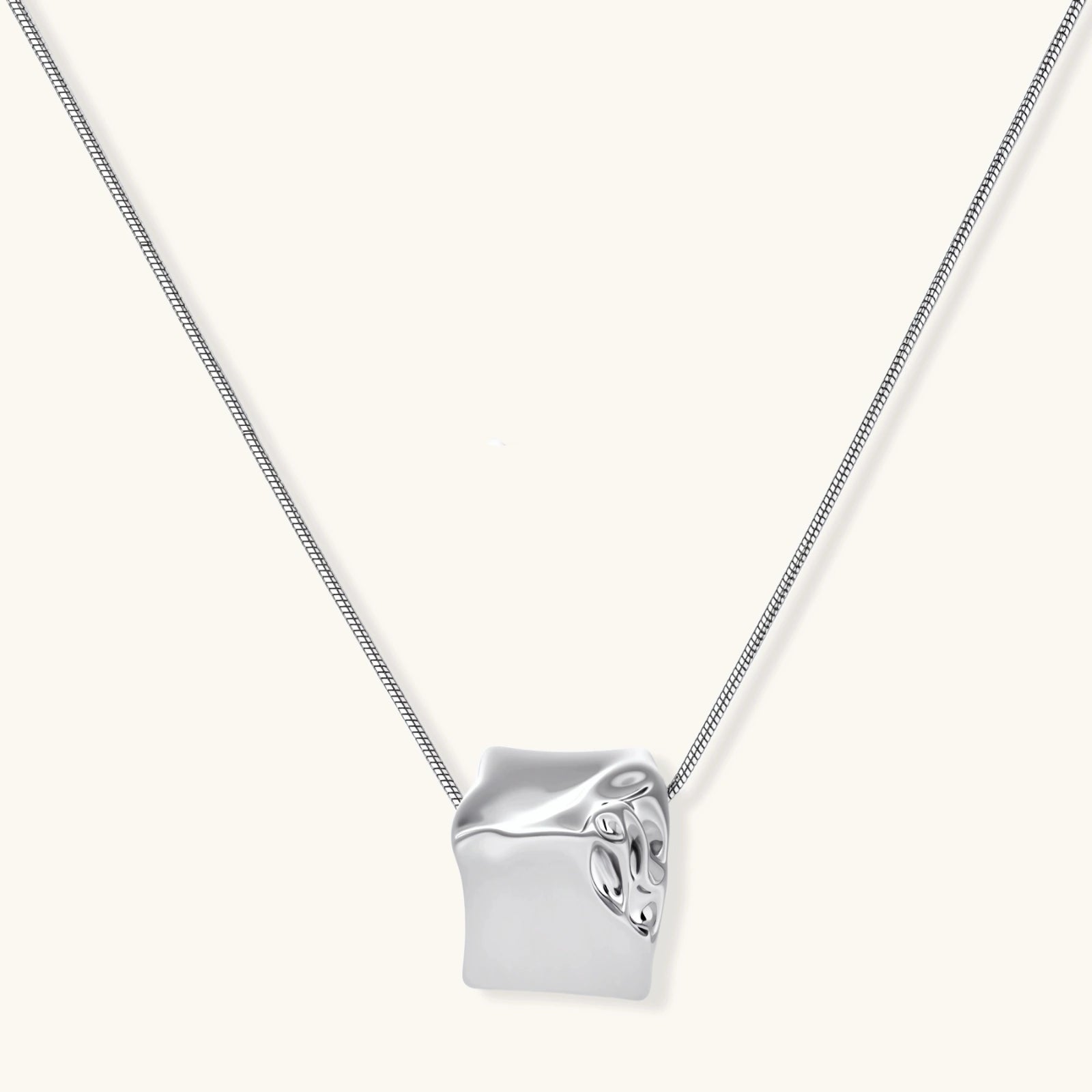 Geometric jewelry set with textured cube pendants on chains, featuring eco-zinc alloy in silver and gold finishes.